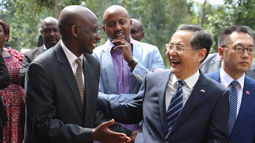Kaboneka (L) chats with Amb Rao Hongwei.
