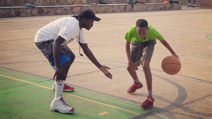 Patrick Habiyaremye challenges one of his mentees to dribble past him in a past session. File photo.