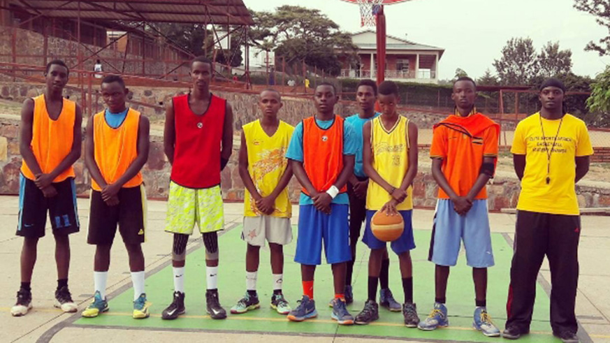 Patrick Habiyaremye (right) poses for a group photo with the youth team he mentors through Elite Sports Africa. File photo.