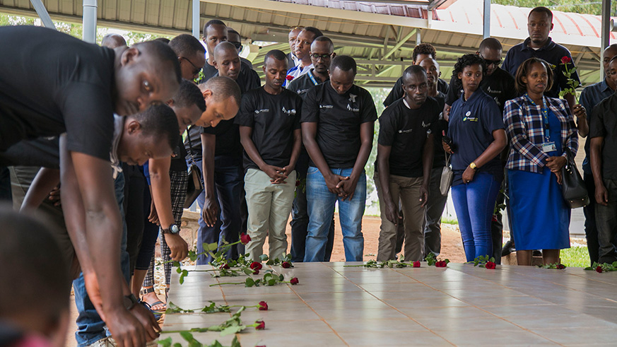 Rwandair deputy CEO Silver Munyaneza lays a wreath of flower on one of the four mass graves where over 11000 bodies of genocide victimes are buried at Nyanza Kicukiro genocide memorial. Kelly Rwamapera