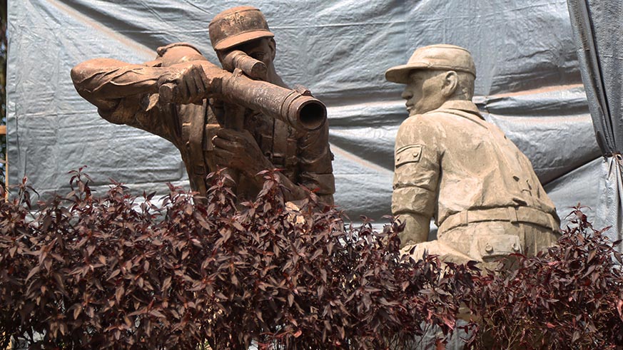 Monument  which is under construction shows  two soldiers with one soldier firing a machine gun.