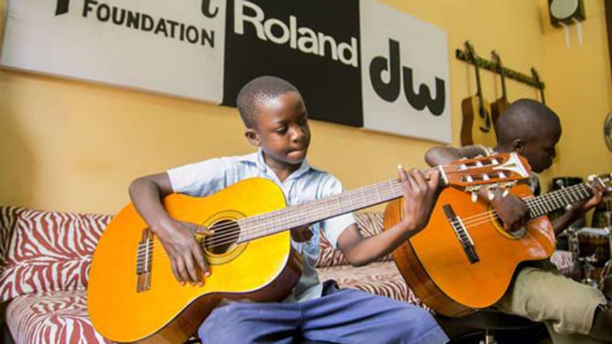 Young boys practising their guitar skills at Rwanda Rocks music school./ Courtesy