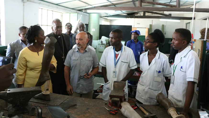 Minister Gashumba and other officials tour HVP Gatagara Orthopedics laboratory where a variety devices are made. Diane Mushimiyimana.
