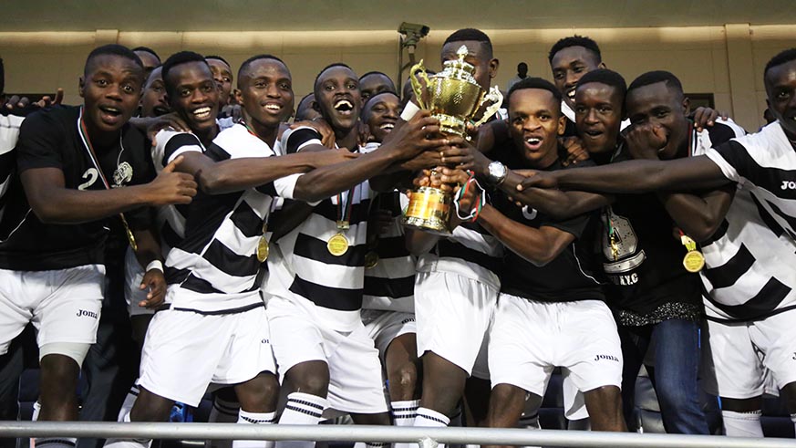 Intare FC players hold the trophy to celebrate their crucial victory to win the Second Division league title after beating Muhanga 2-1 yesterday (Sam Ngendahimana)