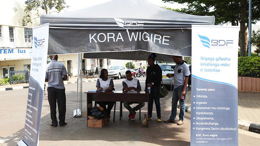 BDF workers talk to people about their services at Kigali Car free Zone. Sam Ngendahimana.