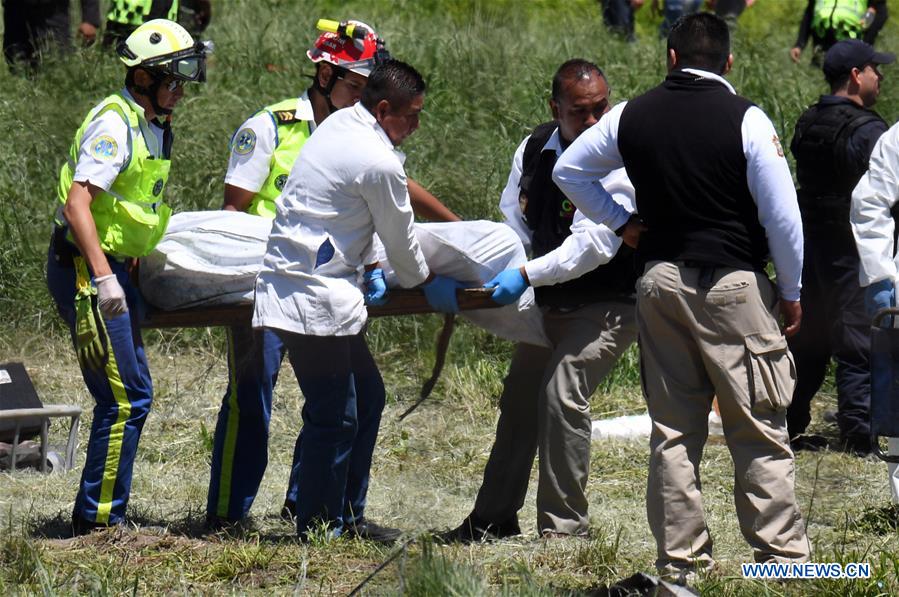 Rescuers carry the body of a victim after explosions at a small fireworks factory in La Saucera, a neighborhood on the outskirts of Tultepec, Mexico, on July 5, 2018. Two explosions on Thursday at the small fireworks factory in central Mexico left at least 19 people dead, including firefighters and police officers, and another 40 people injured, local authorities said. (Xinhua/Fernando Ramirez)
