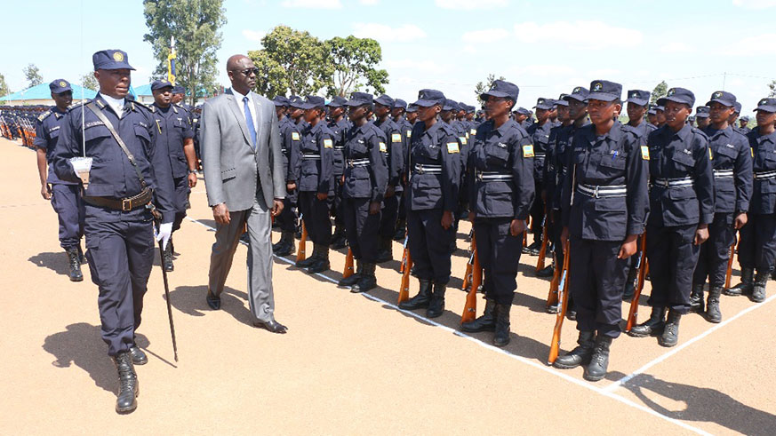 Minister Busingye inspects a guard of honour mounted by the new officers yesterday. Courtesy. 