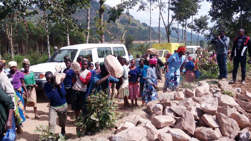 Some of Burera residents carrying stones which will be used to construct Rubona Health Post during community work. Regis Umurengezi