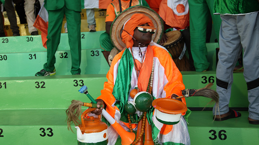Niger national team supporter carries some kitchen tools during the match against Nigeria in CHAN in Rwanda. / Sam Ngendahimana