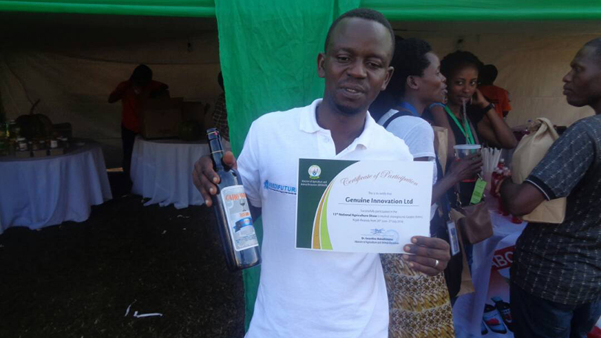 Marc Niyigeza, shows his wine from carrots during the recent agriculture show. Michel Nkurunziza