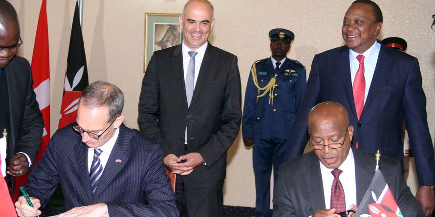 President Uhuru Kenyatta (right) and Swiss counterpart Alain Berset (left) witness the signing of a framework agreement for return of stolen assets stashed in Switzerland to Kenya by the Swiss Ambassador to Kenya Ralf Henker and Attorney General Paul Kihara June 9, 2018. / Courtesy of NMG