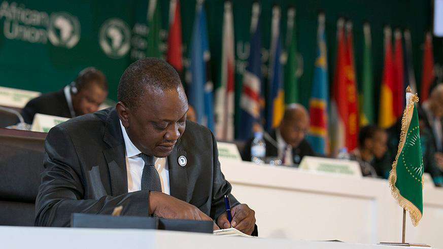 Kenyan President Uhuru Kenyatta signs the AfCFTA  agreement. File. 