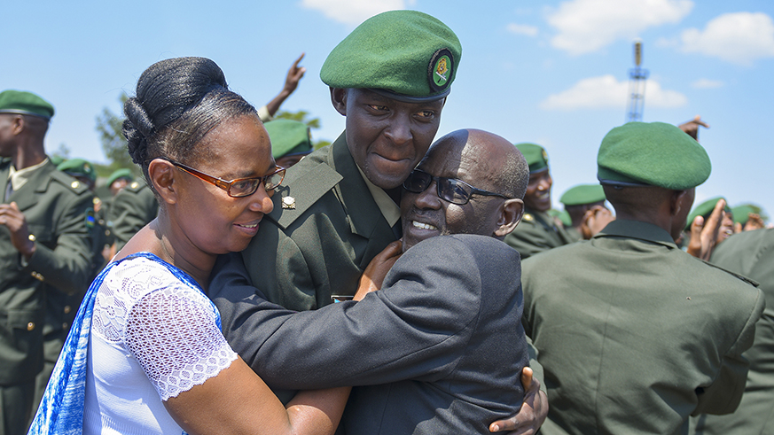 Parents hug a one of the officers after he was commissioned.