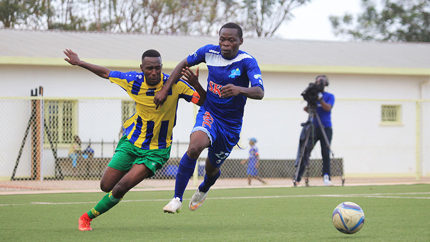 AS Kigali defender Sother Kayumba vie for the ball with Rayon Sports midfielder Pierrot Kwizera. Sam Ngendahimana.