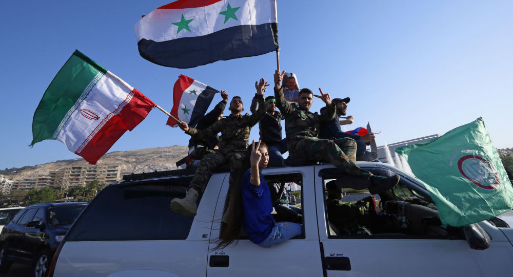 Syrian government supporters wave Syrian, Iranian and Russian flags as they chant slogans against U.S. President Trump during demonstrations following a wave of U.S., British and French military strikes to punish President Bashar Assad for suspected chemical attack against civilians, in Damascus. / Sputnik