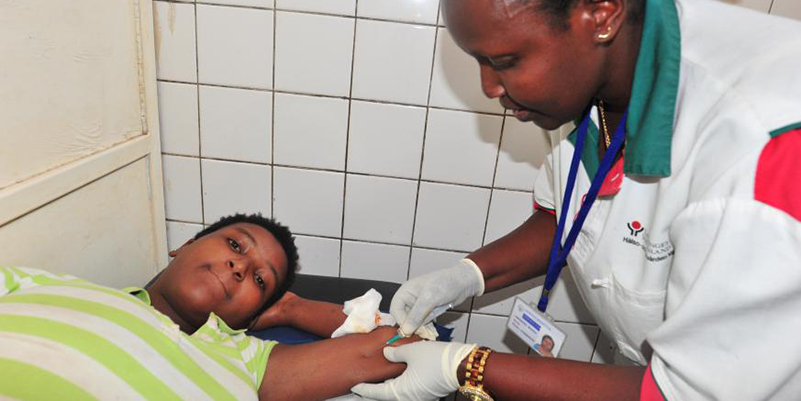 A nurse taking care of a patient. / Courtesy