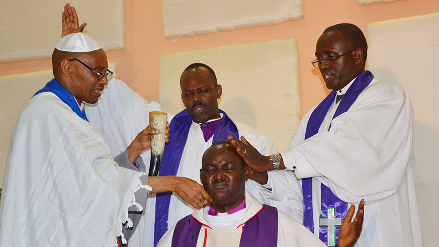 L-R: Born-again senior clerics Bishops Charles Rwandamura, Fidu00e8le Masengo and Albert Rugamba pray for their colleague at Bethesda Holy Church at Gisozi in Kigali. Sam Ngendahimana.