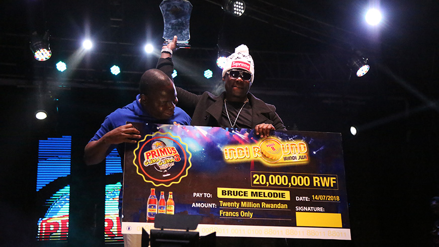 PGGSS season 8 winner Bruce Melodie recieves the trophy and cheque yesterday (Sam Ngendahimana)