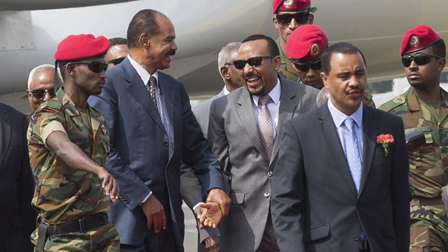Eritrean President Isaias Afwerki, centre left, is welcomed by Ethiopia's Prime Minister Abiy Ahmed. Net.