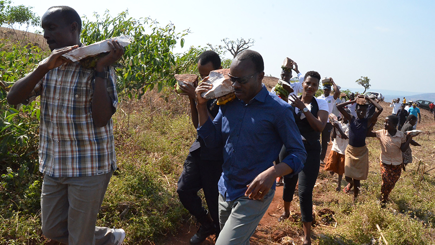 Before the event, the officials and residents officially started the Umuganda Month by transporting stones to build the new schoolâ€™s toilettes.
