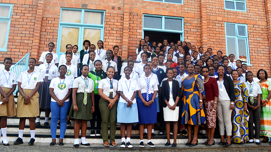 Women leaders pose in a group photo with young girls from the seven schools. (Frederic Byumvuhore)