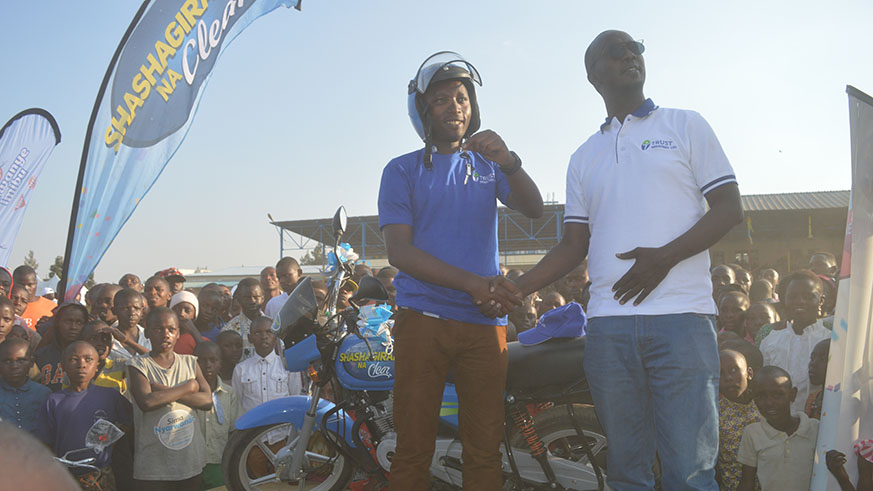 David Kamanda hands over the motor cycle to Nizeyimana