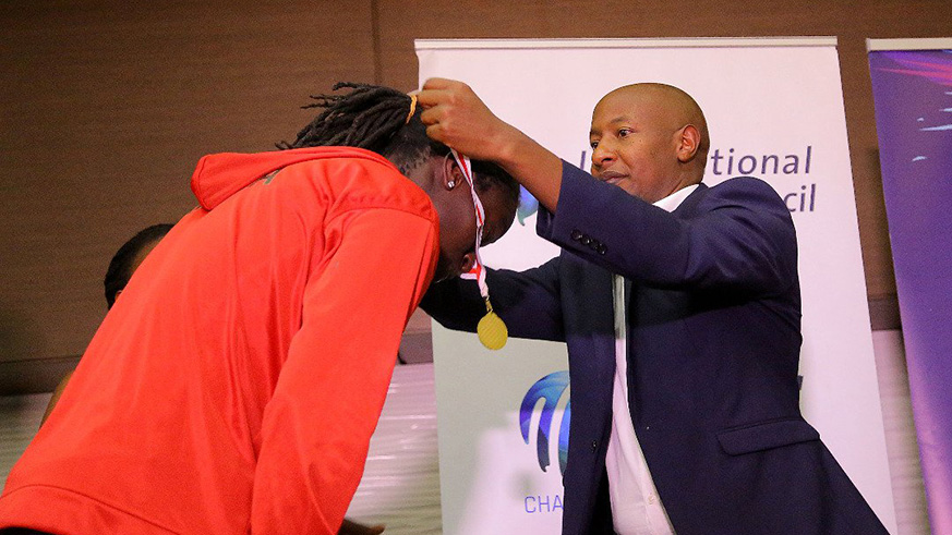 Rwanda Cricket Association president, Eddie Balaba gives out a medal to a Kenyan player at the closing ceremony of ICC World Twenty20 Africa B qualifiers in Kigali. (Courtesy)