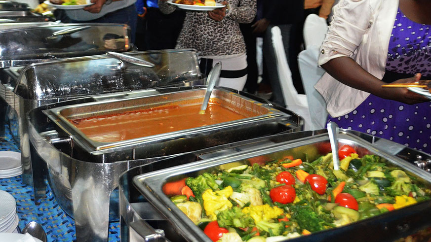 Clients serve food at a KIgali restaurant. Sam Ngendahimana.