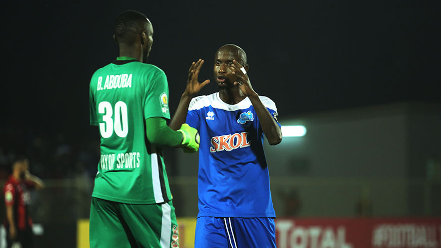 Defender Thierry Manzi speaks to his goalkeeper Abouba Bashunga during the match