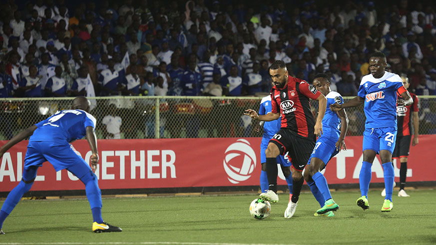 USM Alger's forward Rafik Bouderbal dribbles past Rayon Sports defender Thierry Manzi during 2-1 match in Kigali