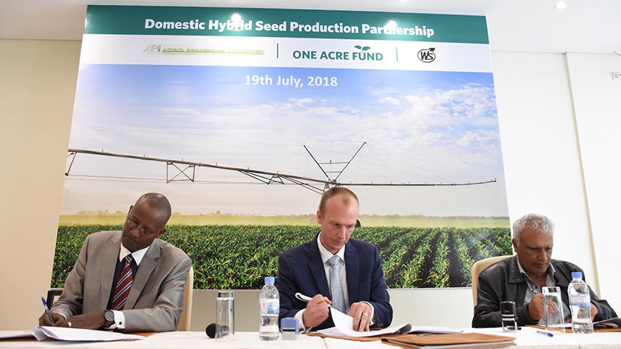 Saleem Esmail, CEO, Western Seed Company (R), Eric Pohlman, Managing Director, One Acre Fund (Centre), and Olivier Rugema, Managing Director, API (L) sign the partnership in Kigali on Thursday