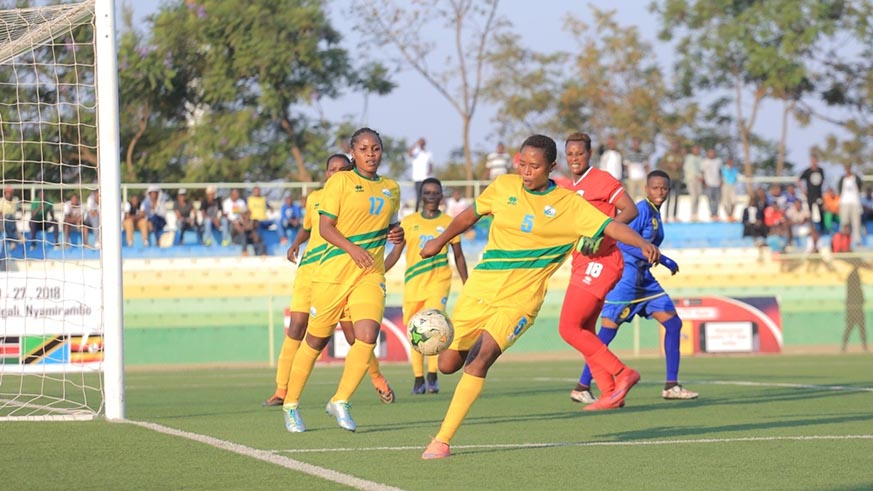Rwanda international Clementine Mukamana clears the ball from She-Amavubiu2019s box against Tanzania on Thursday as skipper Sifa Nibagwire( #17) and goalie Judith Nyirabashyitsi (#18) watch on. Courtesy.