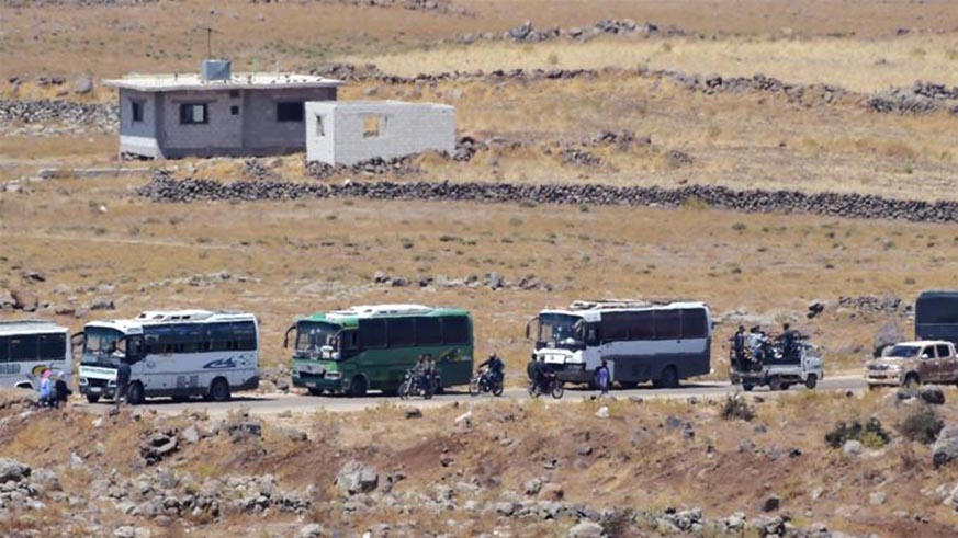 Buses line up at border as seen from the Israeli-occupied Golan Heights. Net photo