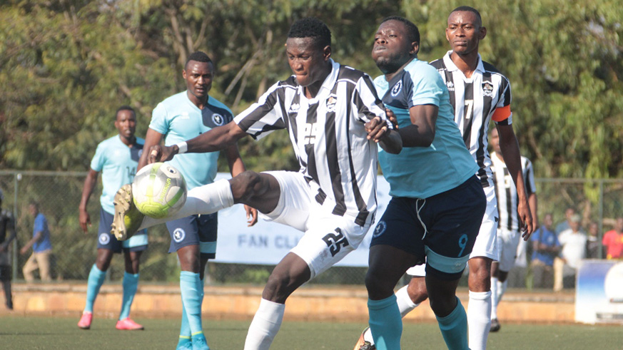APR full-back Fitina Omborenga shields the ball from Police striker Isaie Songa during the two sidesu2019 goalless draw on Friday. Courtesy.