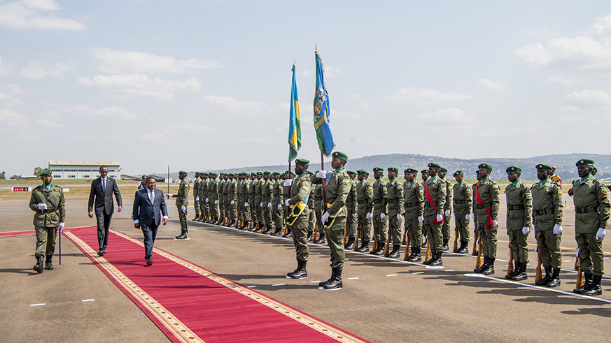 The Mozambian president inspects a guard of honour mounted by the Rwanda Defence Forces on his arrival at Kigali International Airport on Thursday. Village Urugwiro.