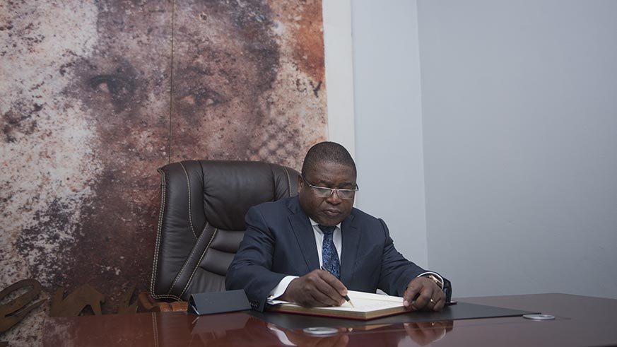 The visiting President signs the guest book at Kigali Genocide memorial on Friday. Courtesy.