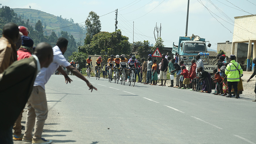 Supporters cheer on riders during the race as they reach at Mukamira
