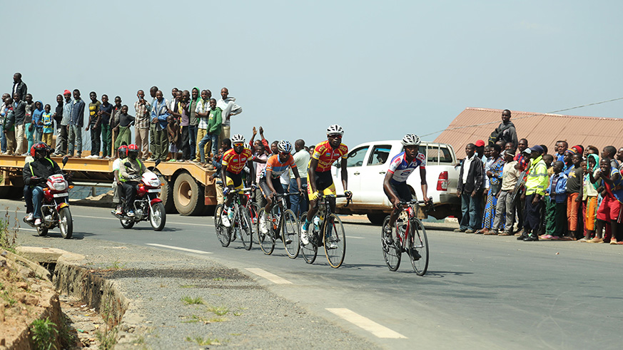 Cycling spectators cheer on riiders in a break away  in Rutsiro