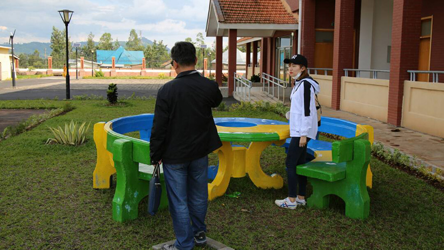 A couple of foreigners testing the furniture produced from cement by three Rwandan Students. Regis Umurengezi