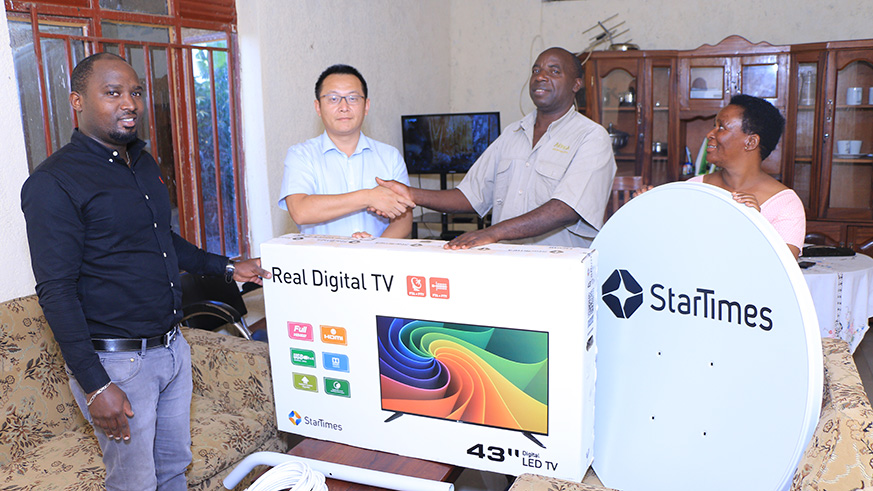Star Times CEO, Jess Jing donates their first client from 2008, Rugwiza Severien with her wife startimes digital TV Flat 43 inch plus VIP forever subscription. Photos Emmanuel Kwizera.