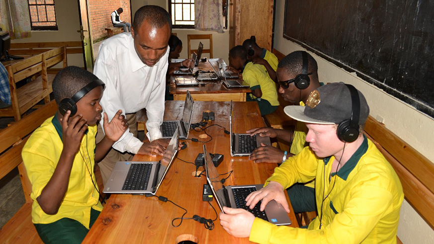 Vuguziga with some of his visually impaired students during an IT class. 