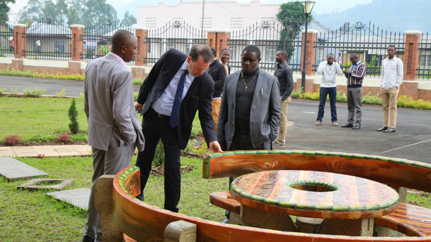 The principal of IPRC Musanze (L) and other officials check on the garden furniture that are made from cement three students. 