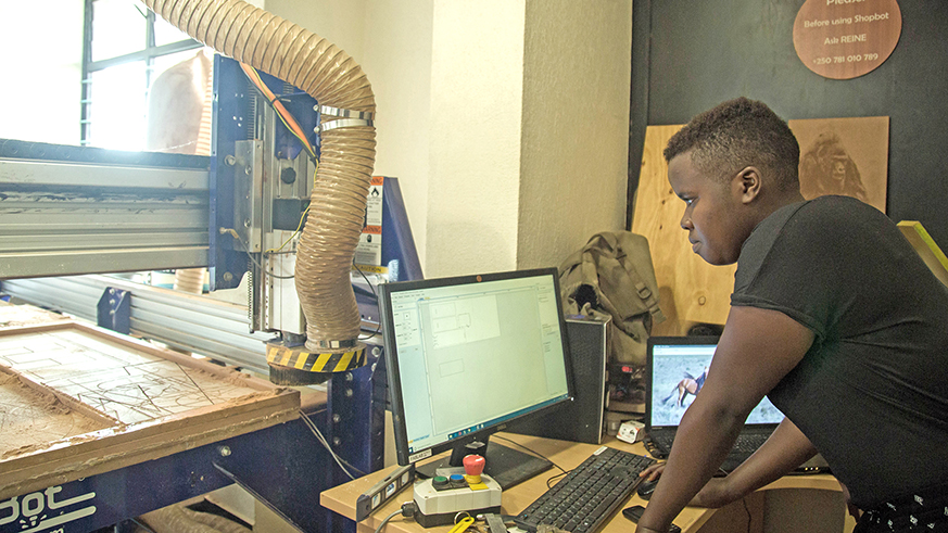 Using a computer helps Imanishimwe come up with unique designs. 