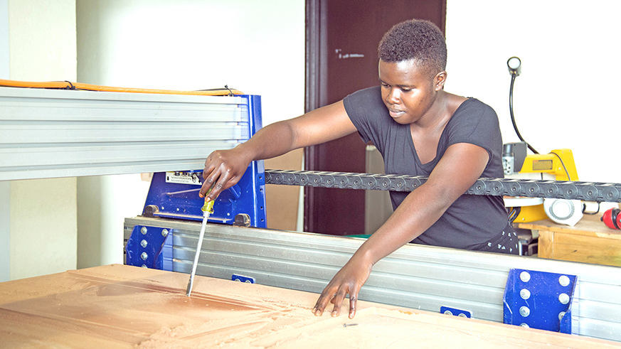 Using a computer helps Imanishimwe come up with unique designs. 