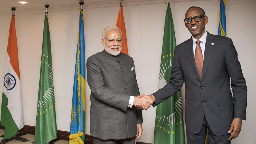 Indian Prime Minister Narendra Modi and President Kagame pose for a picture against the backdrop of their countries and African Unionâ€™s flags in Kigali on Monday. Village Urugwiro.
