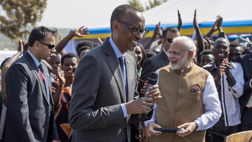 President Paul Kagame and Prime Minister Narendra Modi with residents of Rweru in Bugesera District on Tuesday. Two hundred households in the village received a cow each from the visiting Indian leader.