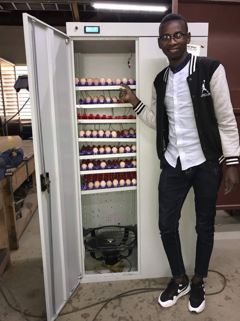 Bora Imani, 23-years old, with one of his incubators that hatches 996 eggs 