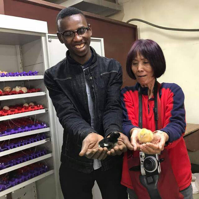Imani holding chicks from the smart incubator 