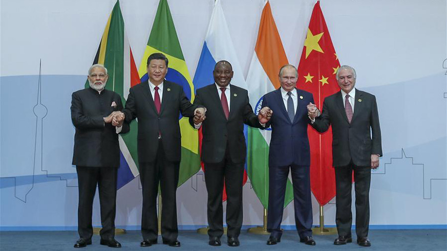 Chinese President Xi Jinping (2nd L), Brazilian President Michel Temer (1st R), Russian President Vladimir Putin (2nd R), Indian Prime Minister Narendra Modi (1st L) and South African President Cyril Ramaphosa pose for a group photo during the Plenary Session of the 10th BRICS summit in Johannesburg.