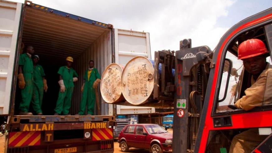 Workers at Mineral Supply Africa Company load containers of minerals on to trucks. File.